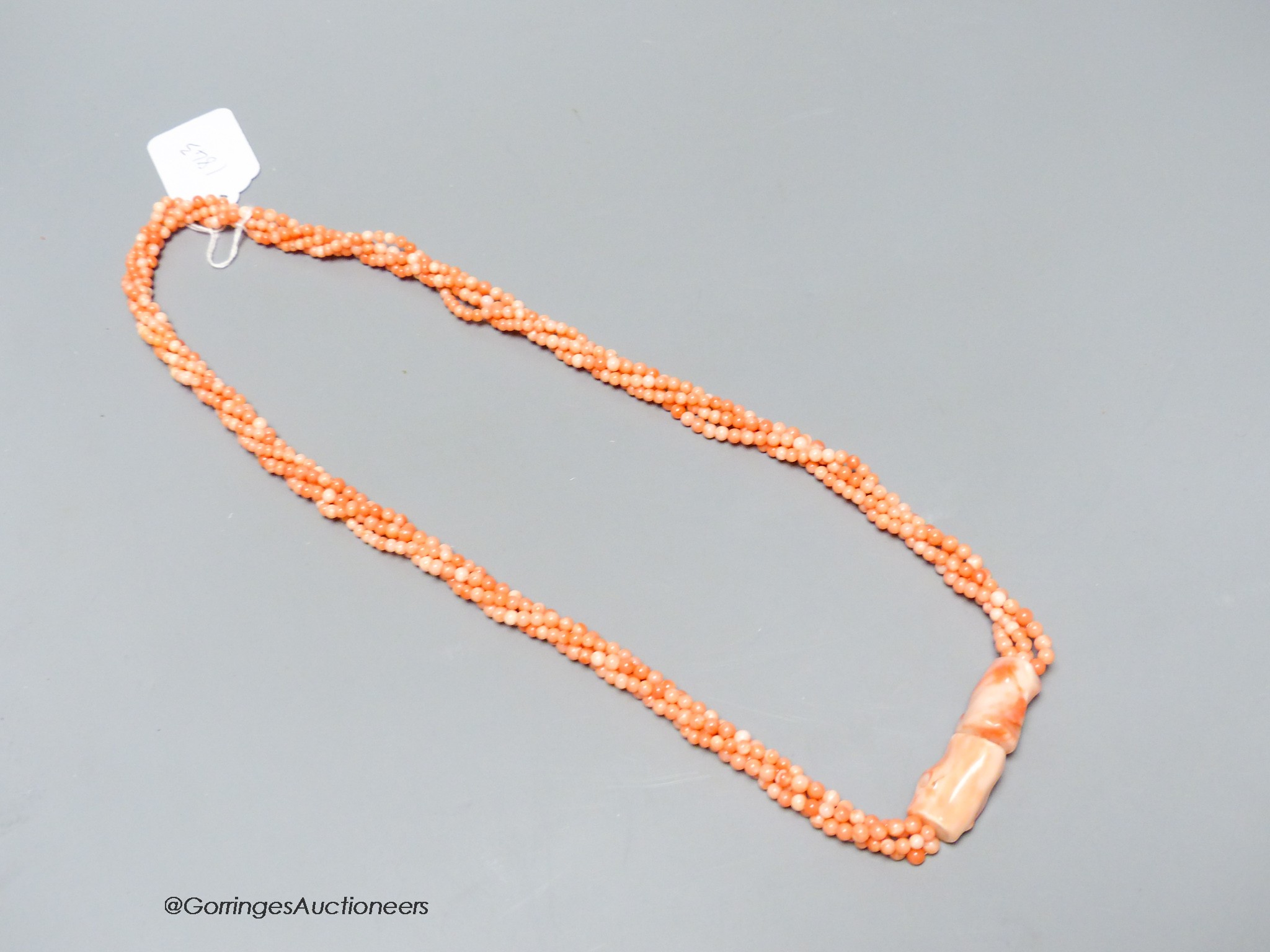 A modern twisted quadruple strand coral bead necklace, 78cm.